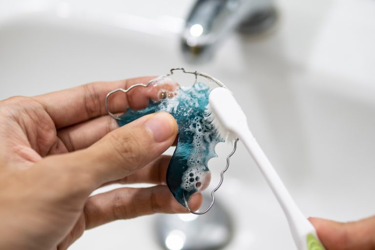 cleaning retainer with toothbrush